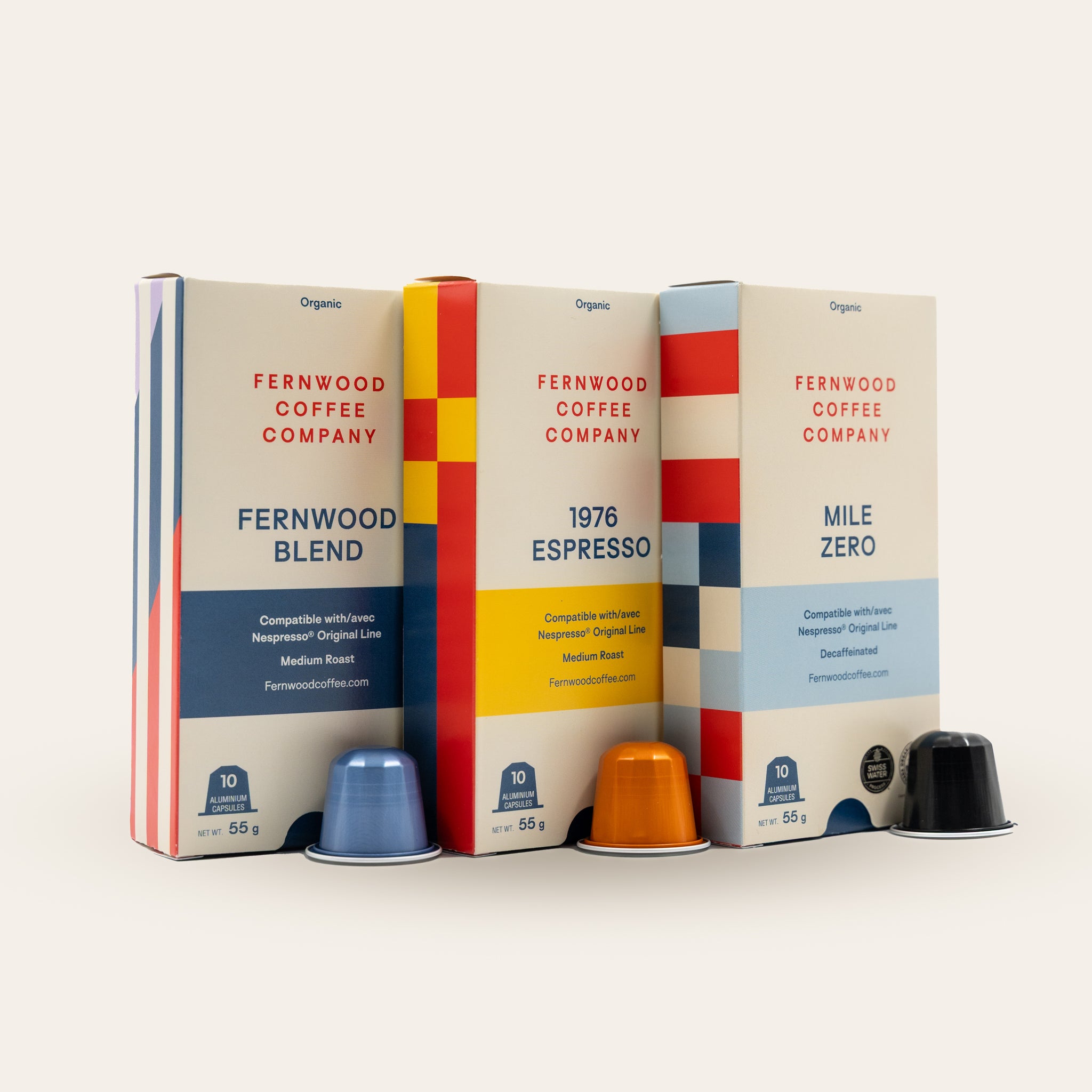 Three packages of Fernwood Coffee Company coffee pods on a beige background