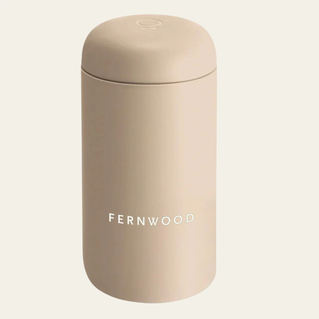 Beige travel mug with 'FERNWOOD' branding on a white background