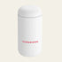 White travel mug 'FERNWOOD' branding on a beige background