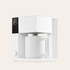 A matte white FELLOW Aiden Precision Coffee Maker with a single cup placed inside, set against a plain background.