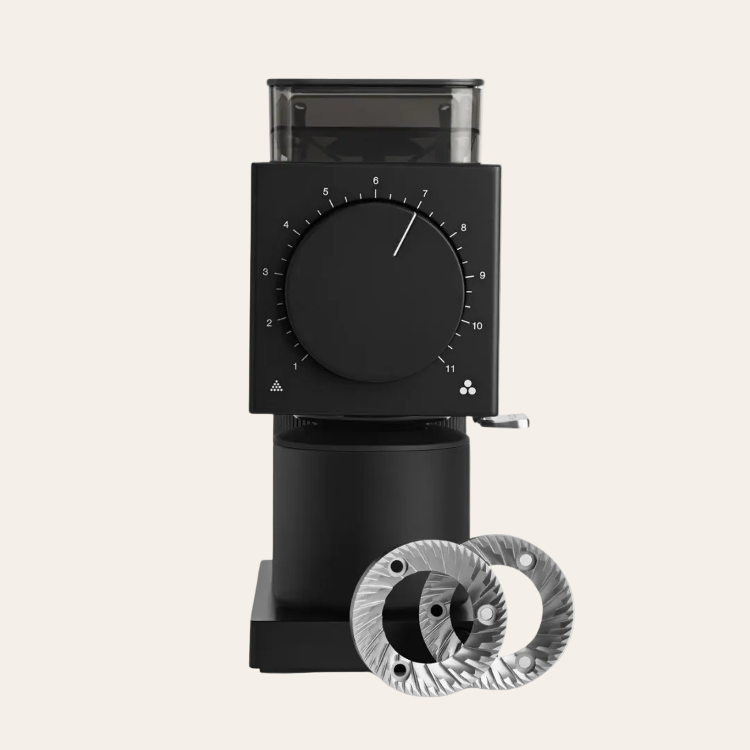 A black Fellow Ode Burr Grinder (Gen 2.0) with visible grinding wheels, dial interface, and bean hopper.