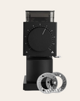 A black Fellow Ode Burr Grinder (Gen 2.0) with visible grinding wheels, dial interface, and bean hopper.