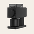 Fellow Ode Black coffee grinder on a light beige background