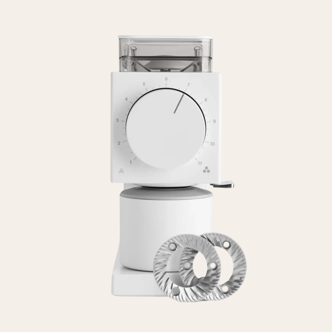 White coffee grinder with a circular dial and additional component on a white background