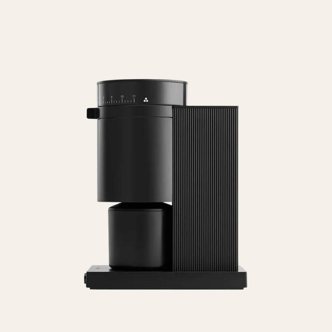 Black coffee machine on a beige background