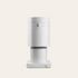 White coffee grinder with a dial on a beige background
