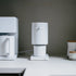 White coffee grinder on a kitchen counter with a blurred background