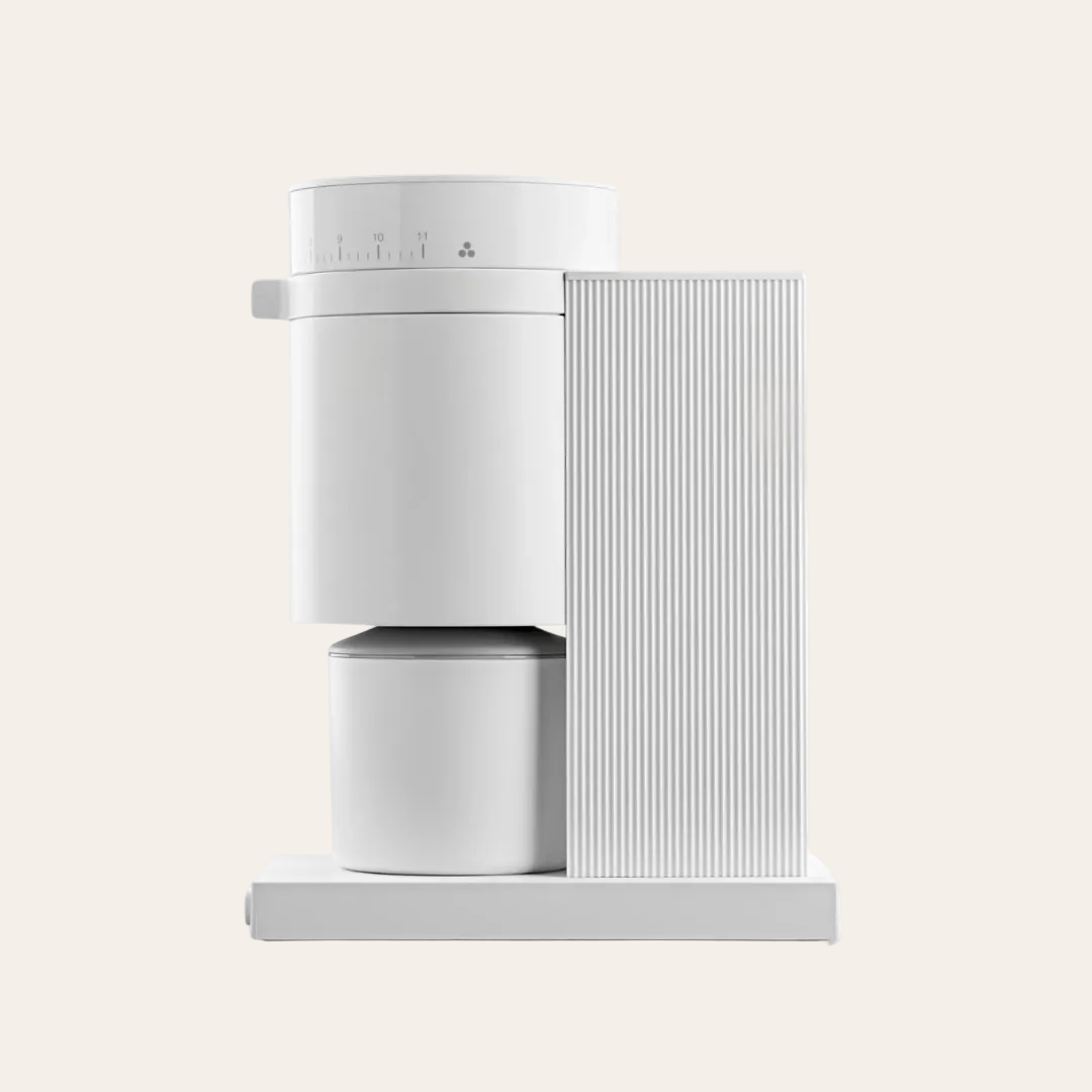 A matte white coffee grinder with a sleek design, featuring a digital display and a removable bean container.