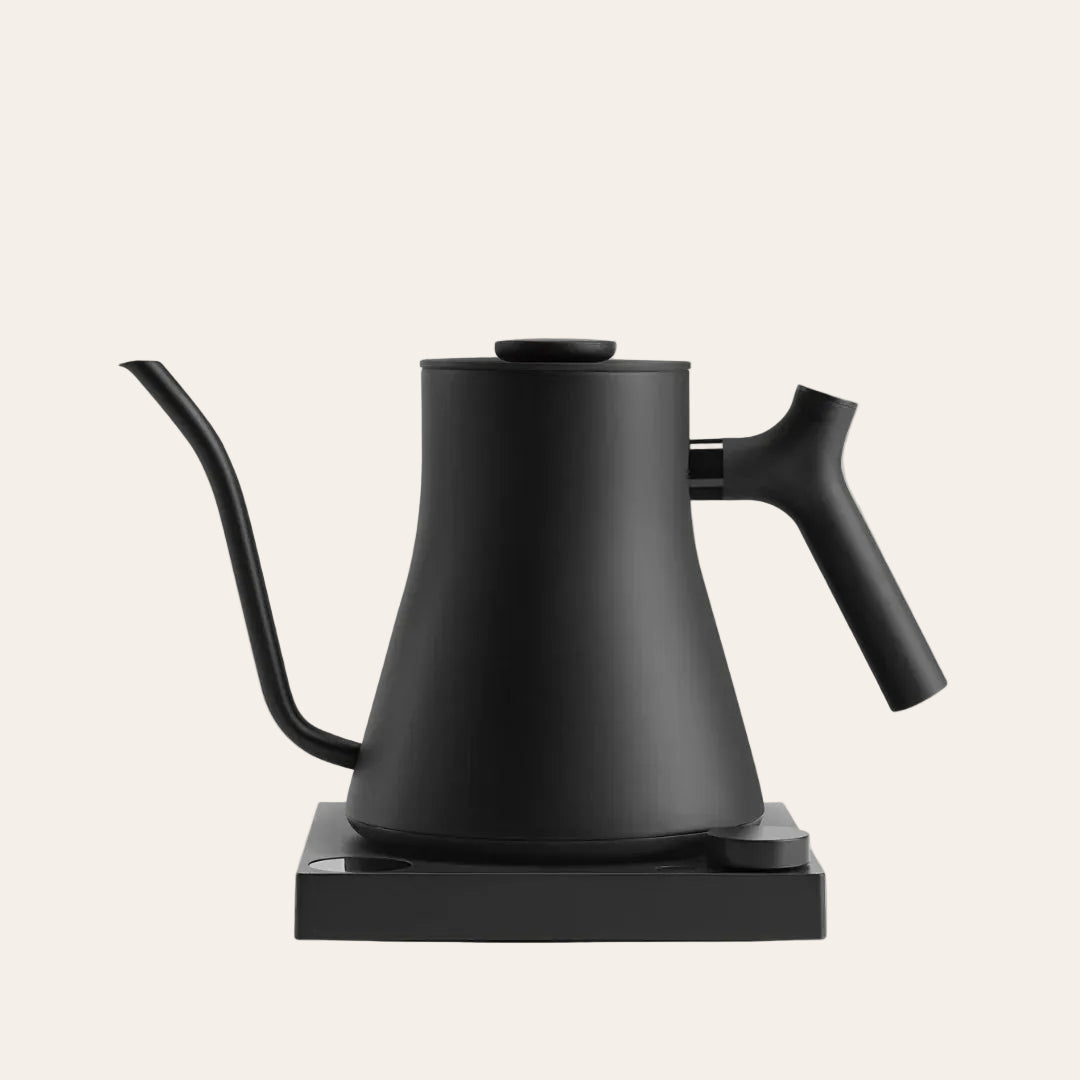 Black electric kettle on a beige background