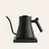 Black electric kettle on a beige background