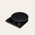 Black digital kitchen scale on a beige background