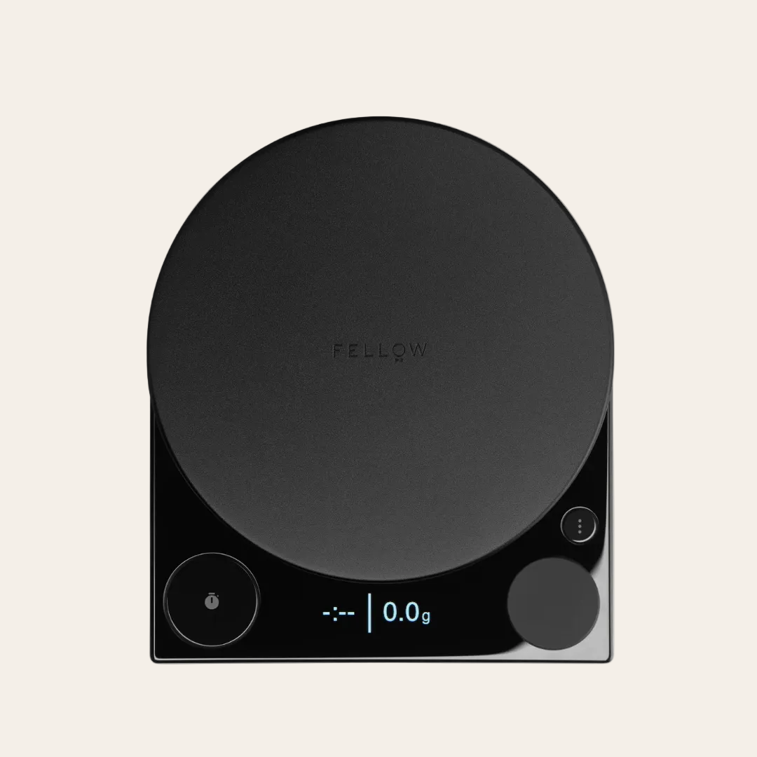 Black digital kitchen scale with 'Fellow' branding on a beige background