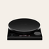 A black precision scale with a round weigh pan, digital display showing weight measurements, and control buttons.