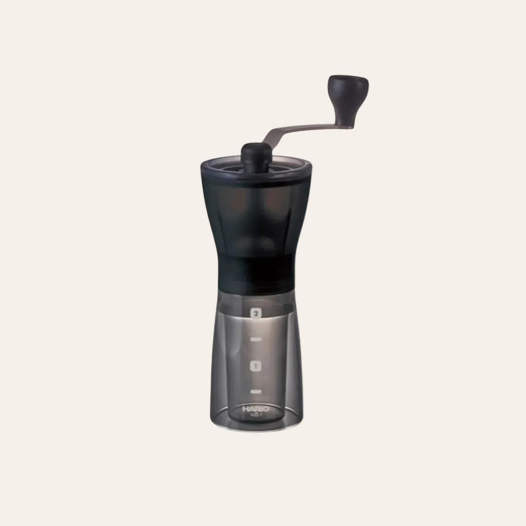 Black manual coffee grinder with crank lever-style handle.