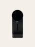 Black coffee maker on a beige background