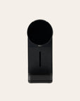 Black coffee maker on a beige background