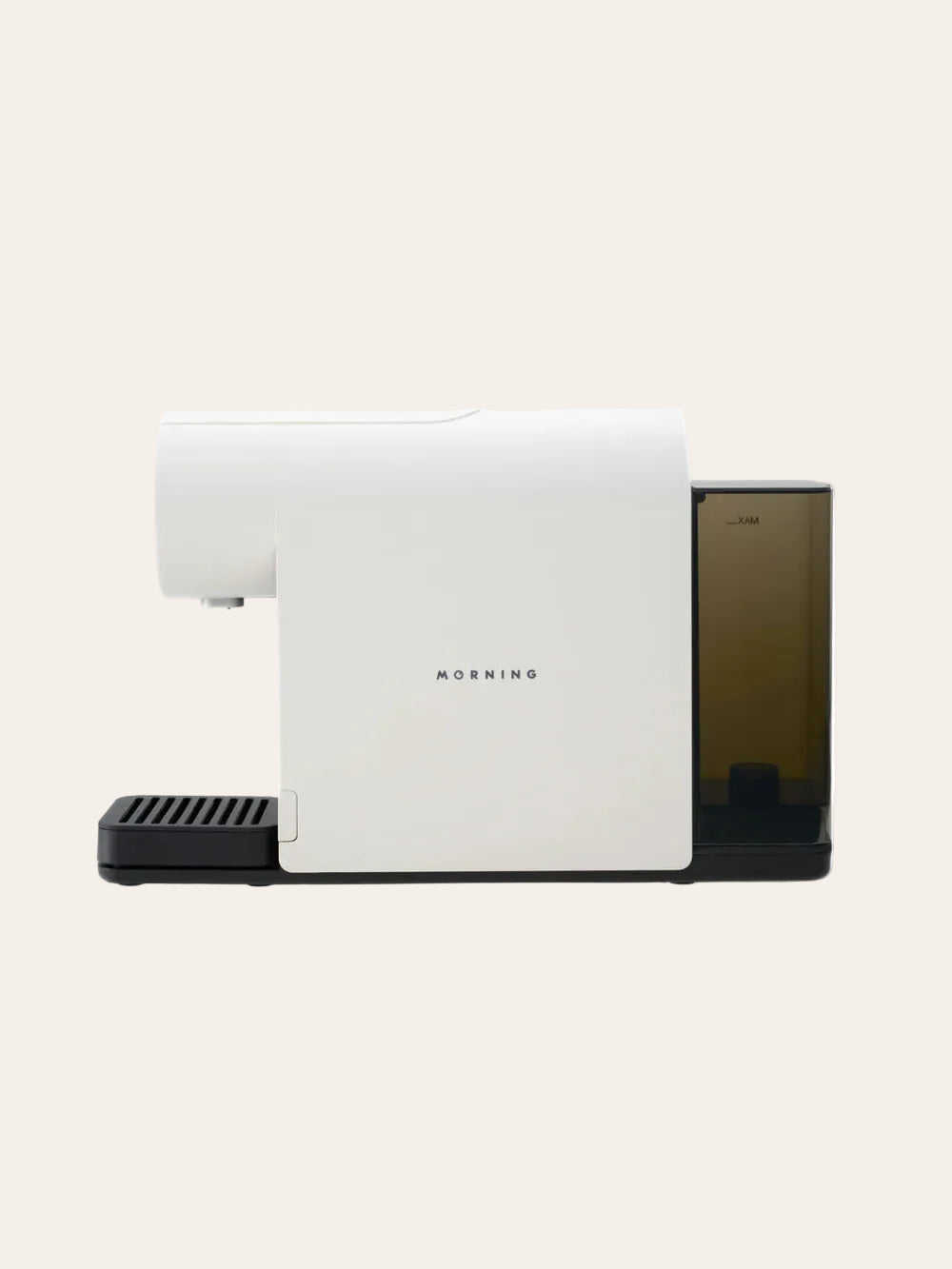 White espresso machine with a black base on a beige background