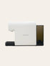 White espresso machine with a black base on a beige background