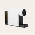 White and black coffee machine on a beige background