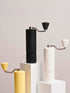 Nuttii Goosey hand grinders in black, off-white and yellow on white display blocks
