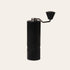 Black Nuttii Goosey hand coffee grinder with a fluted body and conical handle knob