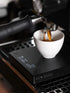 Digital coffee scale with espresso mug on it.