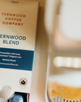 Fernwood Blend coffee capsule brewing packaging brewing a cup with a blurred background