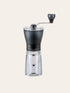 Coffee grinder with clear body and black top on a white background