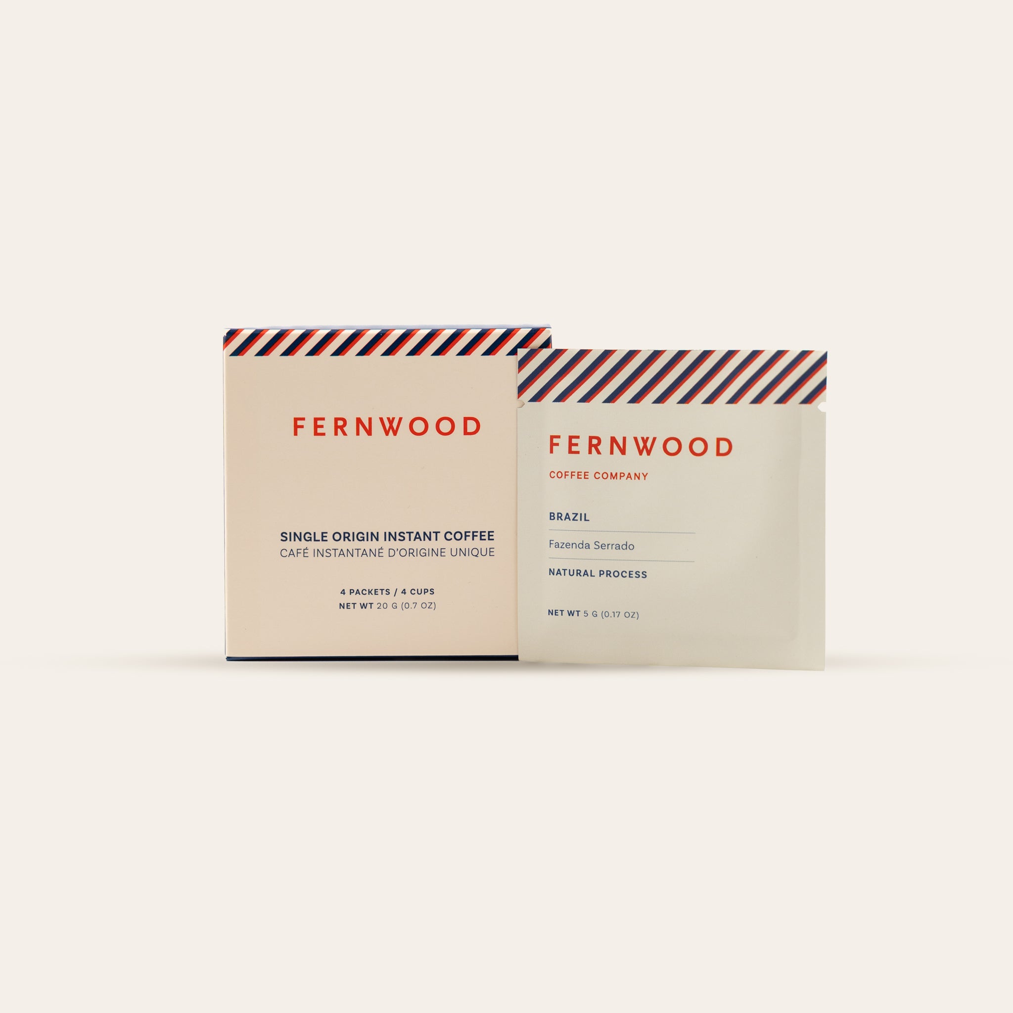 A box and pouch of Brazil Instant Coffee on a beige background.