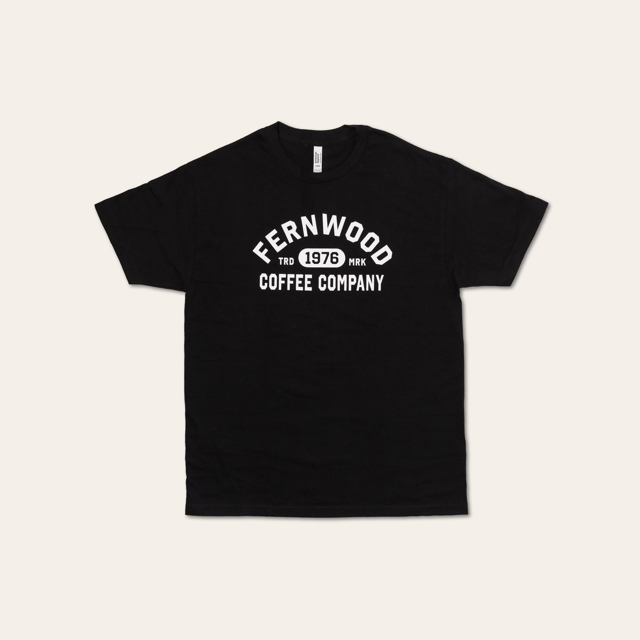 Black t-shirt with 'Fernwood Coffee Company 1976' text on a light beige background