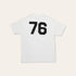 Back of a white tshirt with large 76 numbering in black on a beige background