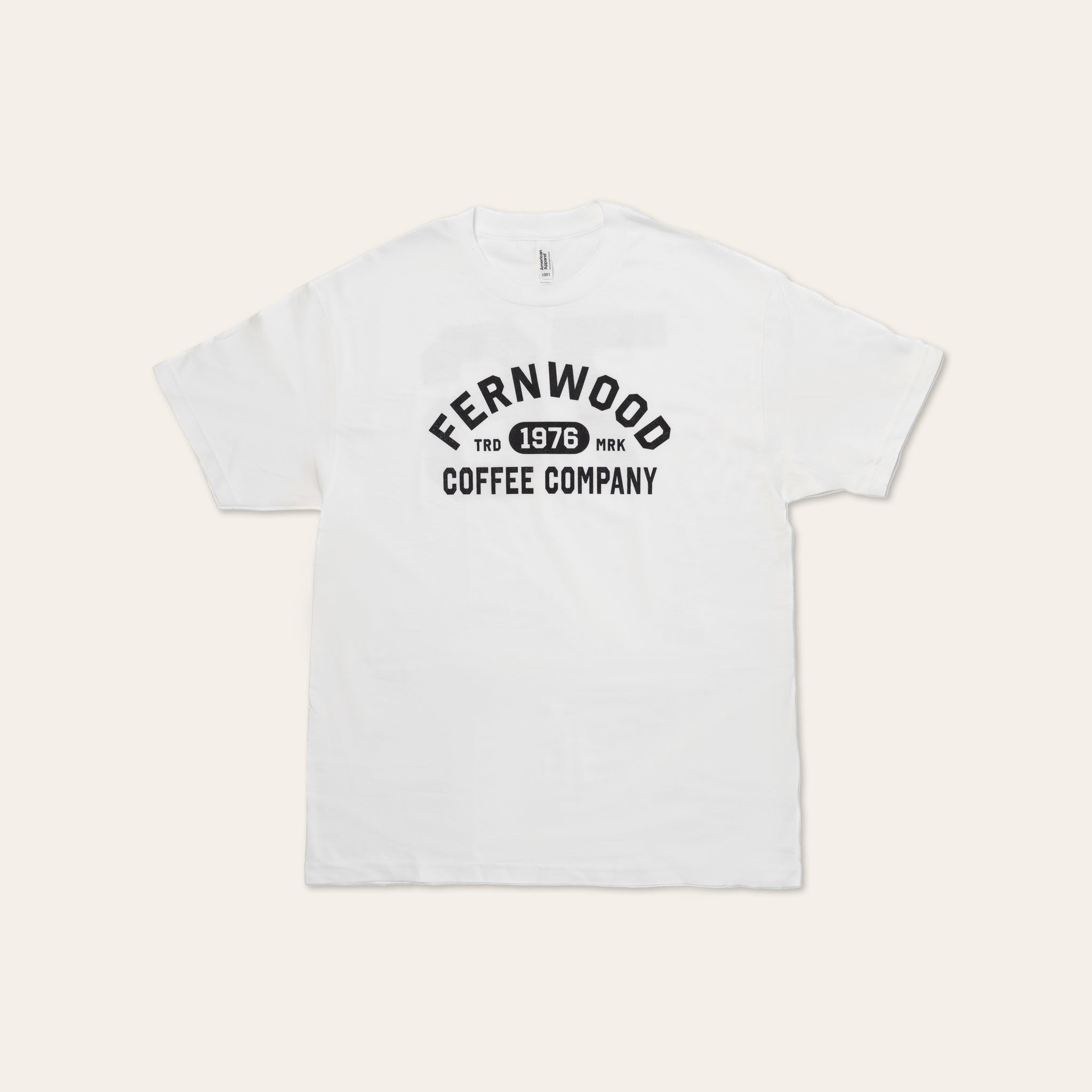 White t-shirt with Fernwood Coffee Company logo 1976 on a beige background