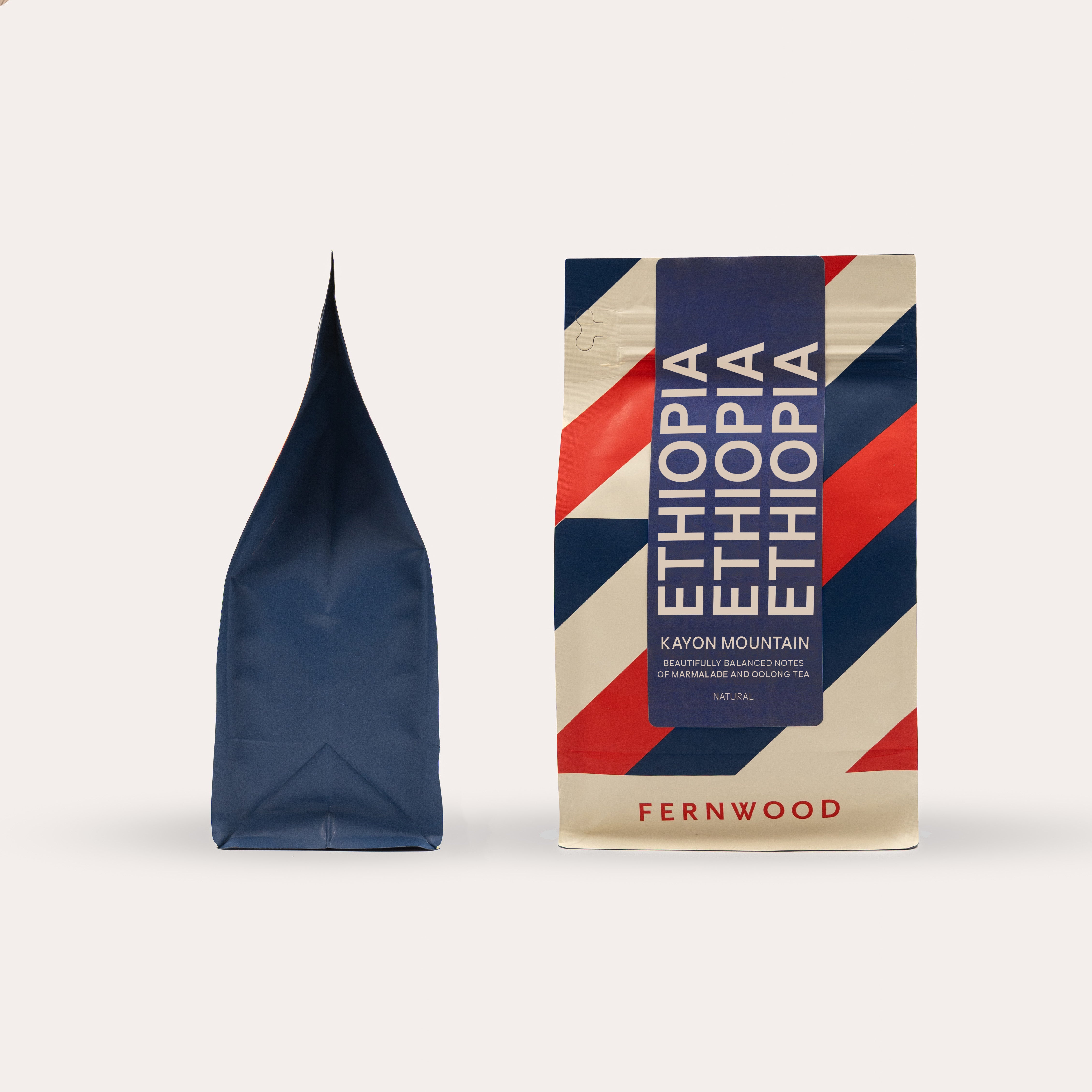 Fernwood Kayon Mountain coffee package with a blue and red striped coffee bag on a beige background.