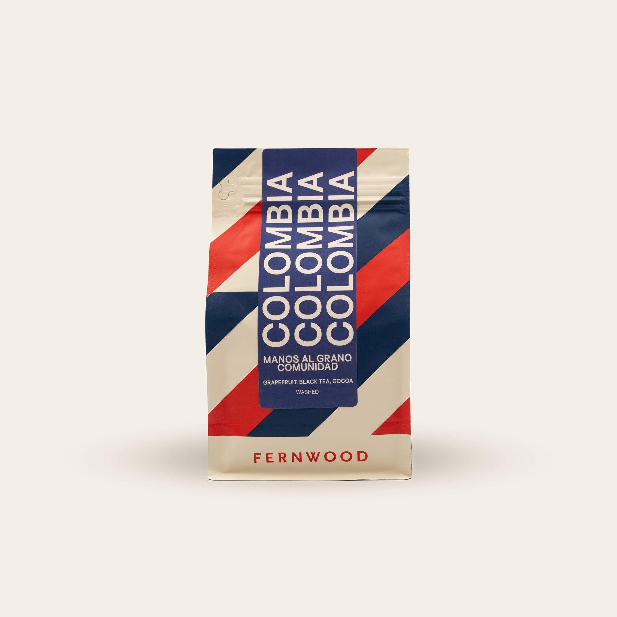 Fernwood branded striped coffee bag on a beige background