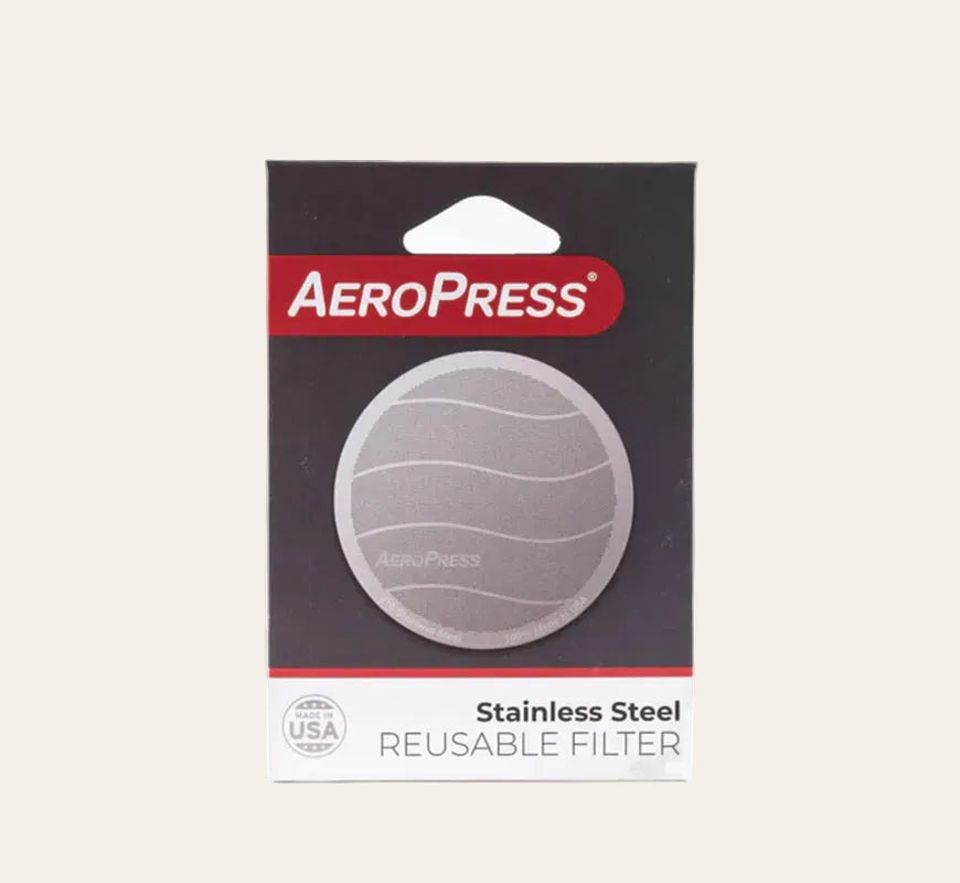 Packaging of AeroPress Stainless Steel Reusable Filter, displaying the filter itself made of silver stainless steel, with the product title and the AeroPress logo.