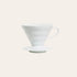 A white ceramic Hario V60-02 dripper, designed for brewing coffee, displayed against a plain background.