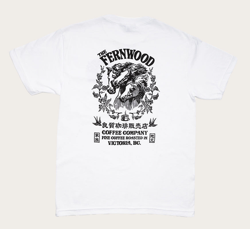A white t-shirt featuring a black printed design of three horse heads and floral elements, with the text 'FERNWOOD COFFEE COMPANY'.
